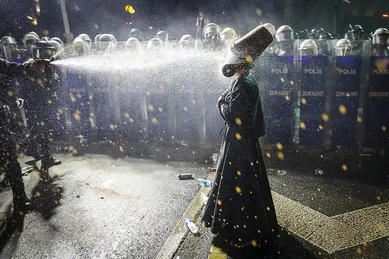 Police-officers-use-pepper-spray-on-a-demonstrator-wearing-dervish-clothes-during-a-protest-on-the-day-Istanbul-Mayor-Ekrem-Imamoglu-was-jailed-as-part-of-a-corruption-investigation-in-Istanbul-Turkey-March-23-2025-REUTERS-Umit-Bektas-TPX-IMAGES-OF-THE-DAY-SEARCH-REUTERS-BEST-2025-FOR-THIS-STORY-SEARCH-REUTERS-2025-YEAR-END-FOR-ALL-2025-YEAR-END-GALLERIES