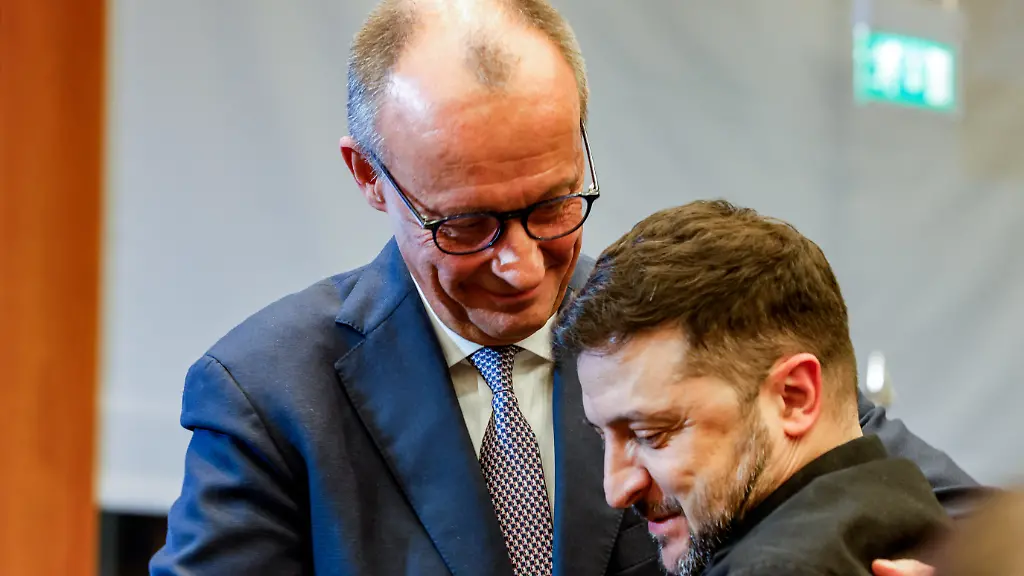 German-Chancellor-Friedrich-Merz-hugs-Ukrainian-President-Volodymyr-Zelenskiy-as-they-attend-the-8th-German-Ukrainian-Business-Forum-at-the-House-of-the-German-Economy-in-Berlin-Germany-December-15-2025