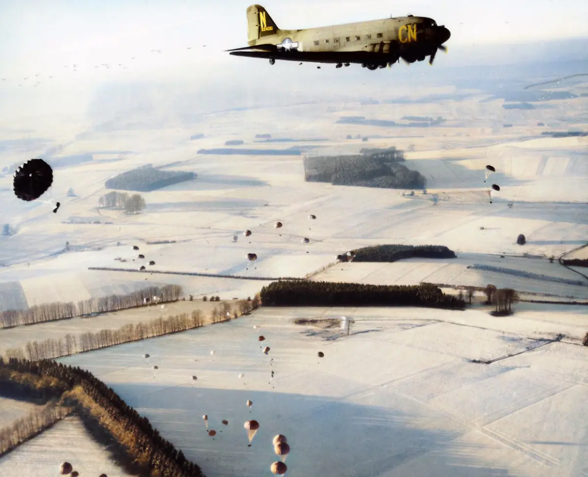 World-War-II-Battle-of-the-Bulge-Ardennes-Offensive-last-major-German-offensive-campaign-on-the-Western-Front-December-1944-January-1945-A-Douglas-C-47-of-the-9th-Troop-Carrier-Command-drop-supplies-over-Bastogne-Belgium-Photo-23-December-1944