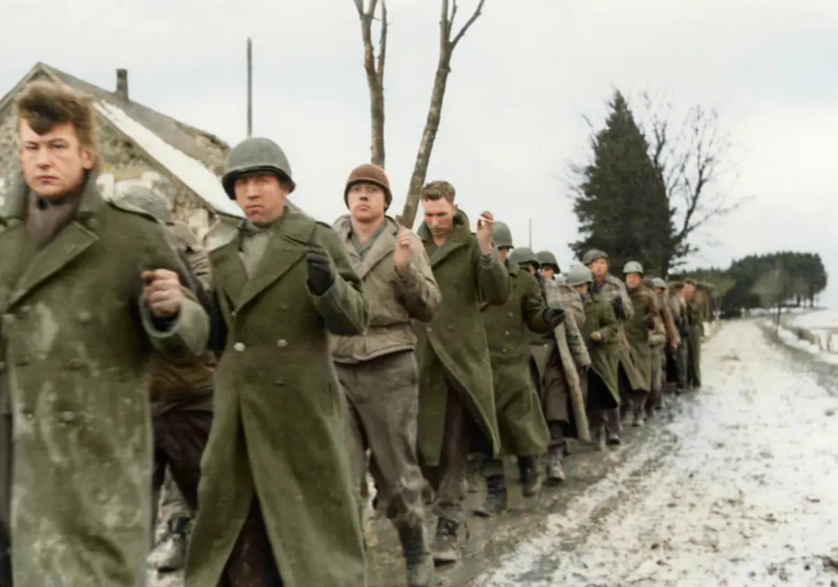 World-War-II-Battle-of-the-Bulge-Ardennes-Offensive-last-major-German-offensive-campaign-on-the-Western-Front-December-1944-January-1945-Captured-American-G-I-s-in-the-Battle-of-the-Bulge-American-prisoners-of-war-are-marched-along-the-road-on-the-western-front-Captured-German-film-Photo-December-1944