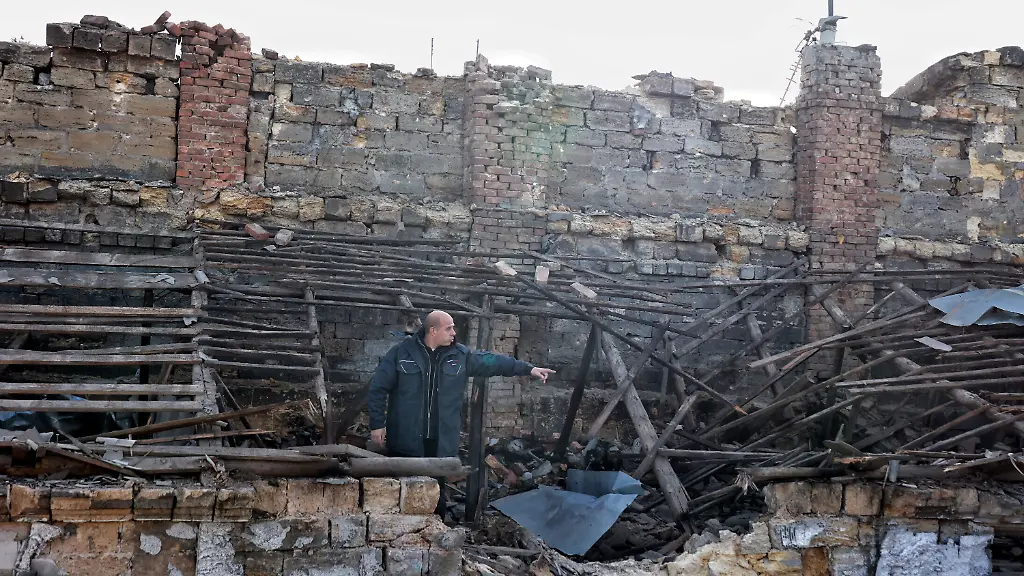 A-man-stands-on-the-roof-of-a-residential-building-damaged-by-a-Russian-strike-Odesa-Ukraine-December-13-2025-During-the-night-of-December-13-Russian-forces-launched-more-than-450-attack-drones-and-around-30-missiles-of-various-types-across-Ukraine-In-Odesa-and-the-region-the-strikes-targeted-energy-port-gas-industrial-and-civilian-infrastructure-Photo-by-Nina-Liashonok-Ukrinform-ABACAPRESS