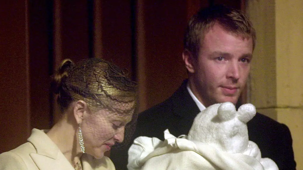 Pop-singer-Madonna-L-looks-down-at-her-son-Rocco-held-by-film-director-Guy-Ritchie-as-they-leave-Dornoch-Cathedral-21-December-2000-The-couple-christened-their-four-month-old-son-Rocco-at-Dornoch-Cathedral-one-day-ahead-of-their-wedding-in-nearby-Skibo-Castle-22-December