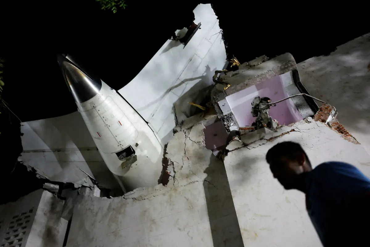 A-person-walks-past-debris-at-the-crash-site-after-an-Air-India-aircraft-bound-for-London-s-Gatwick-Airport-crashed-during-take-off-from-an-airport-in-Ahmedabad-India-June-12-2025-REUTERS-Adnan-Abidi-TPX-IMAGES-OF-THE-DAY-SEARCH-REUTERS-BEST-2025-FOR-THIS-STORY-SEARCH-REUTERS-2025-YEAR-END-FOR-ALL-2025-YEAR-END-GALLERIES