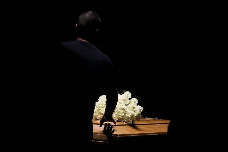A-person-touches-the-coffin-of-designer-Giorgio-Armani-as-he-lies-in-state-at-the-Armani-Teatro-following-his-death-at-the-age-of-91-in-Milan-Italy-September-6-2025-REUTERS-Claudia-Greco-TPX-IMAGES-OF-THE-DAY-SEARCH-REUTERS-BEST-2025-FOR-THIS-STORY-SEARCH-REUTERS-2025-YEAR-END-FOR-ALL-2025-YEAR-END-GALLERIES