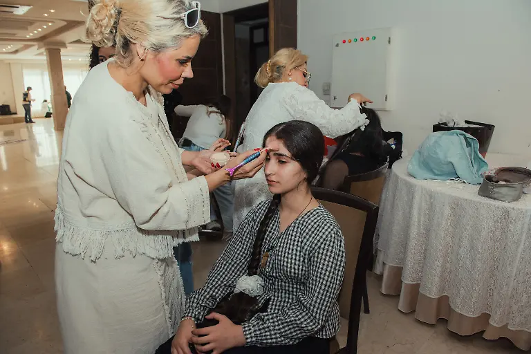 Yeganeh-Farjam-12-gets-her-makeup-done-before-a-catwalk-event-organized-by-the-Mahboob-Tehran-Institute-in-Tehran-Iran-on-September-9-2025-The-organization-led-by-Mahboubeh-Rahimian-works-to-support-people-with-disabilities-and-promote-social-inclusion-through-art-education-and-community-events