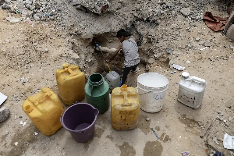 NYTCEASEFIRE-April-24-2025-Jabalia-Camp-Palestinians-are-struggling-to-access-water-due-to-dilapidated-infrastructure-forcing-them-to-transport-it-in-plastic-containers-in-a-traditional-way-With-the-onset-of-famine-this-becomes-even-more-difficult-for-them-because-they-do-not-receive-healthy-food-to-provide-them-with-the-energy-to-perform-these-strenuous-tasks