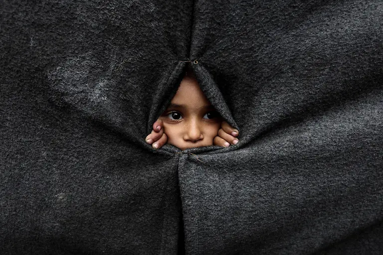 A-displaced-Palestinian-child-looks-through-a-covering-made-from-blankets-as-they-take-shelter-at-an-UNRWA-run-school-after-U-S-President-Donald-Trump-announced-that-Israel-and-Hamas-agreed-on-the-first-phase-of-a-Gaza-ceasefire-in-Khan-Younis-in-the-southern-Gaza-Strip-October-9-2025-REUTERS-Ramadan-Abed-TPX-IMAGES-OF-THE-DAY-SEARCH-REUTERS-BEST-2025-FOR-THIS-STORY-SEARCH-REUTERS-2025-YEAR-END-FOR-ALL-2025-YEAR-END-GALLERIES