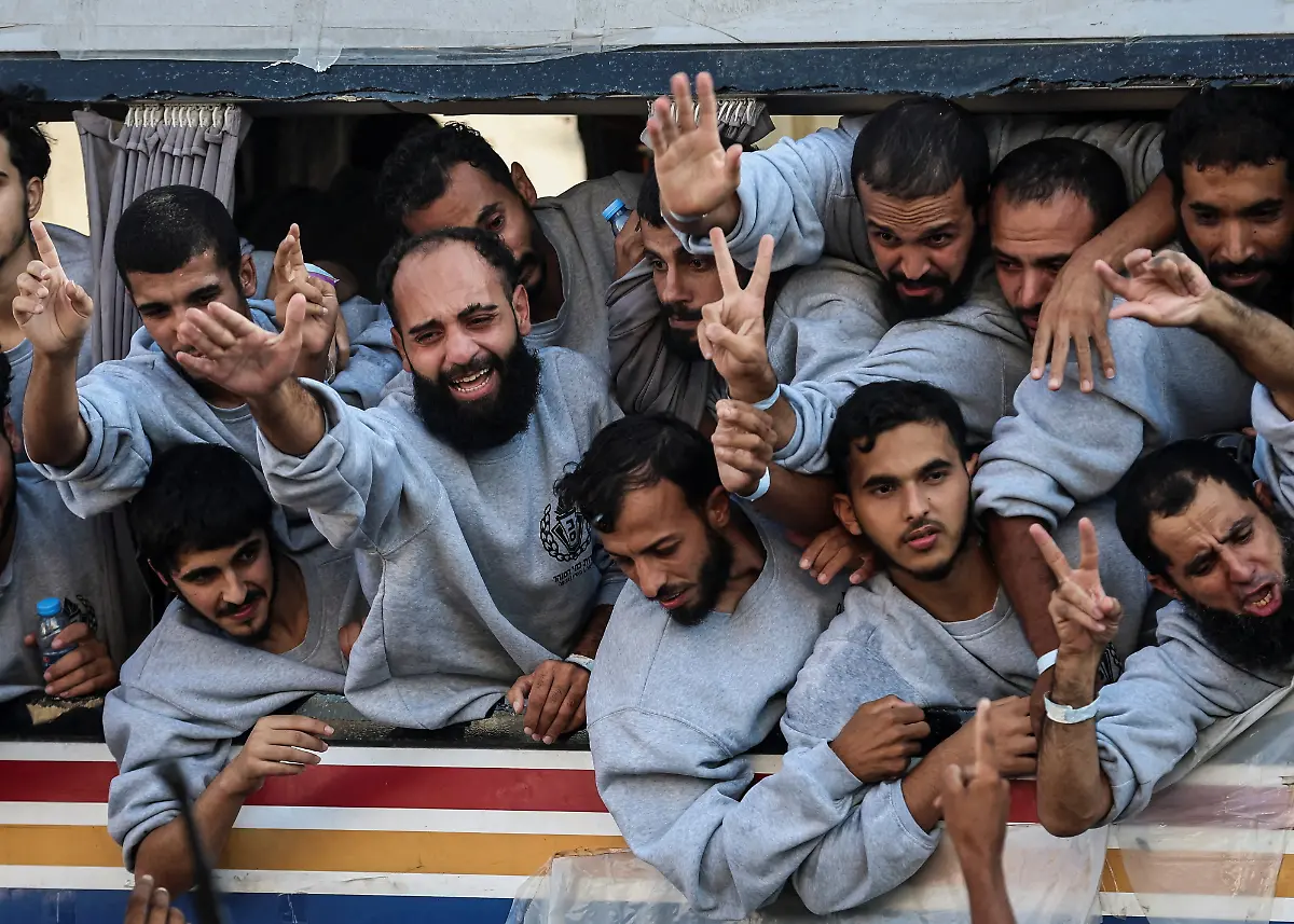 Freed-Palestinian-prisoners-released-by-Israel-as-part-of-a-hostages-prisoners-swap-and-a-ceasefire-deal-between-Hamas-and-Israel-gesture-in-Khan-Younis-in-the-southern-Gaza-Strip-October-13-2025-REUTERS-Ramadan-Abed-TPX-IMAGES-OF-THE-DAY-SEARCH-REUTERS-BEST-2025-FOR-THIS-STORY-SEARCH-REUTERS-2025-YEAR-END-FOR-ALL-2025-YEAR-END-GALLERIES