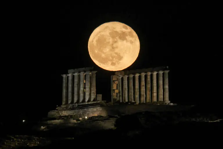 A-full-moon-known-as-the-Strawberry-Moon-shines-over-the-ancient-Greek-temple-of-Poseidon-on-Cape-Sounion-Greece-June-11