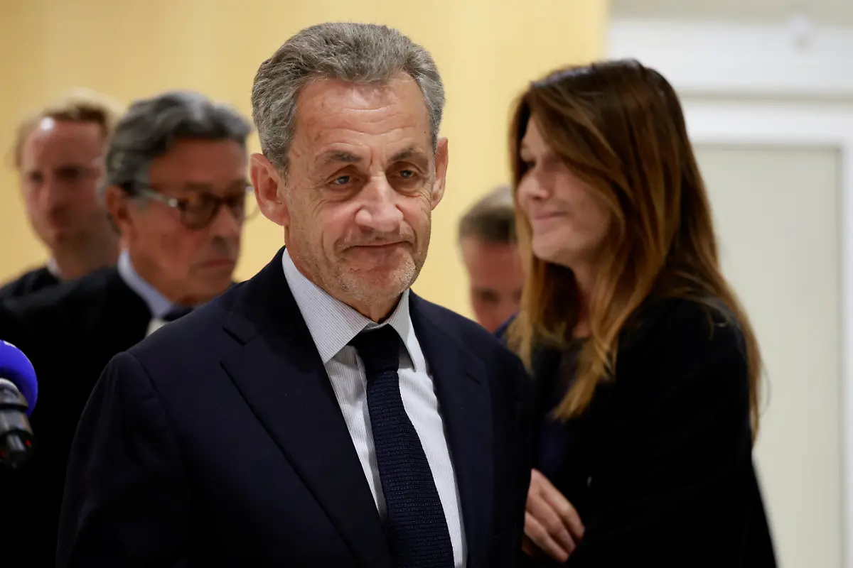 Former-French-President-Nicolas-Sarkozy-reacts-as-he-leaves-with-his-wife-Carla-Bruni-Sarkozy-and-his-lawyers-after-the-verdict-in-his-trial-with-other-defendants-on-charges-of-corruption-and-illegal-financing-of-an-election-campaign-related-to-alleged-Libyan-funding-of-his-successful-2007-presidential-bid-at-the-courthouse-in-Paris-France-September-25
