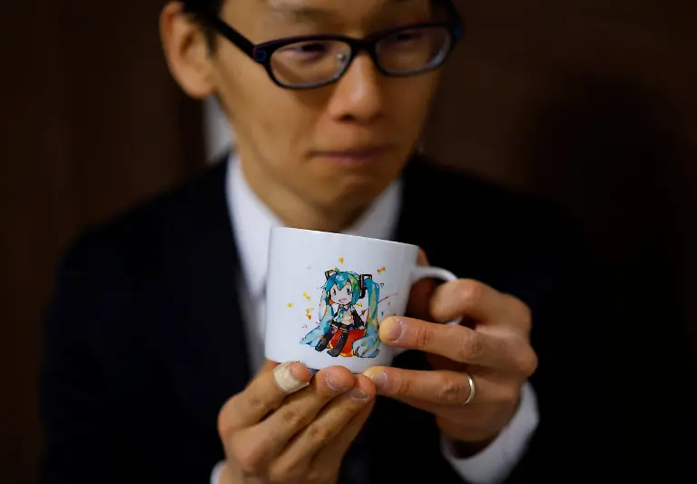 Akihiko-Kondo-43-who-in-2018-married-Hatsune-Miku-a-virtual-pop-idol-drinks-coffee-from-a-mug-featuring-the-character-at-his-home-in-Matsudo-Chiba-Prefecture-Japan-February-24-2025-REUTERS-Kim-Kyung-Hoon-SEARCH-JAPAN-KYUNG-HOON-AI-WEDDING-FOR-THIS-STORY-SEARCH-WIDER-IMAGE-FOR-ALL-STORIES