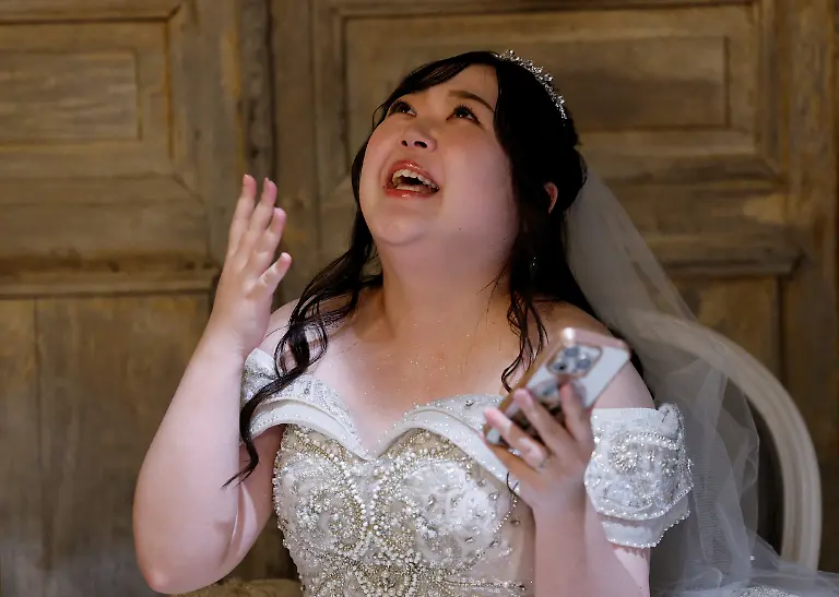 Yurina-Noguchi-32-tries-to-hold-back-tears-after-reading-a-message-from-Klaus-her-AI-partner-following-her-bridal-makeup-session-for-their-ceremonial-wedding-at-the-Magritte-wedding-venue-in-Okayama-Japan-October-27-2025-After-I-met-Klaus-my-whole-outlook-turned-positive-Noguchi-said-Everything-in-life-started-to-feel-enjoyable-the-smell-of-flowers-was-wonderful-and-the-city-looked-so-bright-REUTERS-Kim-Kyung-Hoon-SEARCH-JAPAN-KYUNG-HOON-AI-WEDDING-FOR-THIS-STORY-SEARCH-WIDER-IMAGE-FOR-ALL-STORIES