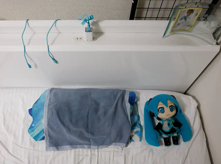 A-doll-of-Hatsune-Miku-a-virtual-pop-idol-sits-on-the-bed-of-Akihiko-Kondo-43-who-married-her-persona-in-2018-at-his-home-in-Matsudo-Chiba-Prefecture-Japan-February-24-2025-REUTERS-Kim-Kyung-Hoon-SEARCH-JAPAN-KYUNG-HOON-AI-WEDDING-FOR-THIS-STORY-SEARCH-WIDER-IMAGE-FOR-ALL-STORIES