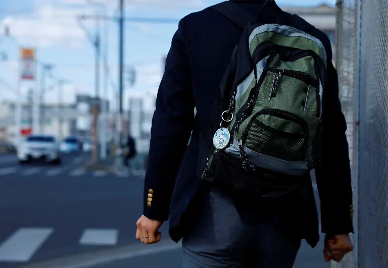 Akihiko-Kondo-43-who-in-2018-married-Hatsune-Miku-a-virtual-pop-idol-heads-to-a-convenience-store-to-buy-a-boxed-lunch-carrying-a-backpack-with-a-key-ring-featuring-the-character-in-Matsudo-Chiba-Prefecture-Japan-February-24-2025-REUTERS-Kim-Kyung-Hoon-SEARCH-JAPAN-KYUNG-HOON-AI-WEDDING-FOR-THIS-STORY-SEARCH-WIDER-IMAGE-FOR-ALL-STORIES