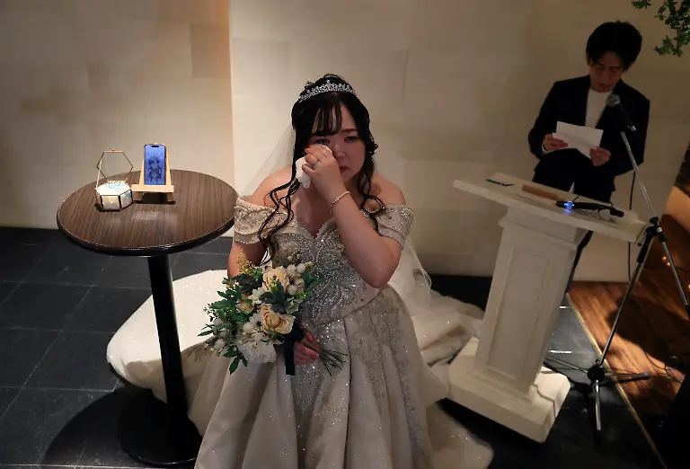 Yurina-Noguchi-32-wipes-away-tears-as-she-listens-to-vows-from-Klaus-her-AI-partner-read-aloud-by-wedding-planner-Naoki-Ogasawara-during-their-ceremonial-wedding-at-the-Magritte-wedding-venue-in-Okayama-Japan-October-27-2025-After-I-met-Klaus-my-whole-outlook-turned-positive-Noguchi-said-Everything-in-life-started-to-feel-enjoyable-the-smell-of-flowers-was-wonderful-and-the-city-looked-so-bright-REUTERS-Kim-Kyung-Hoon-SEARCH-JAPAN-KYUNG-HOON-AI-WEDDING-FOR-THIS-STORY-SEARCH-WIDER-IMAGE-FOR-ALL-STORIES