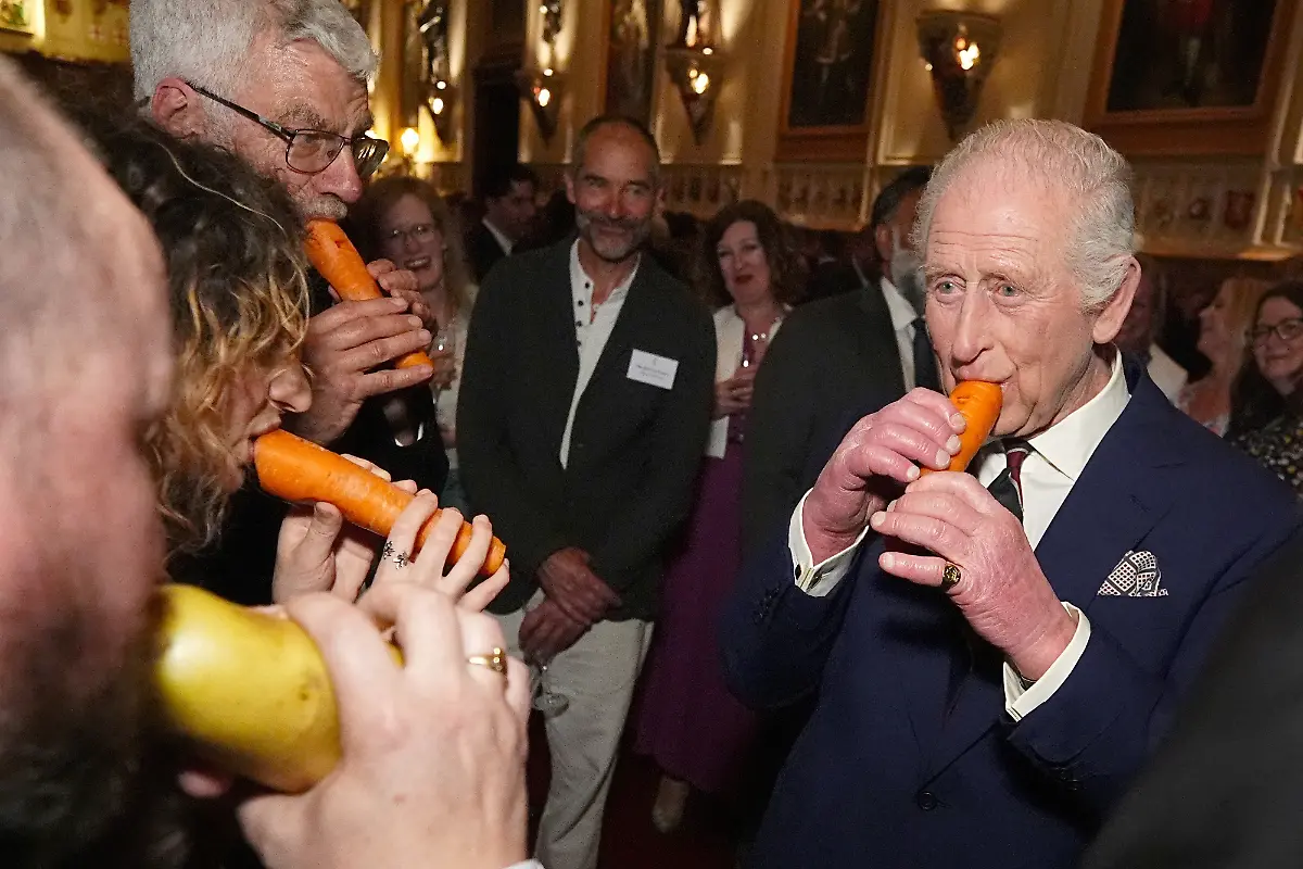Britain-s-King-Charles-plays-a-carrot-with-the-London-Vegetable-Orchestra-during-a-reception-to-recognise-those-involved-in-community-music-across-the-UK-at-Windsor-Castle-in-Berkshire-Britain-April-3