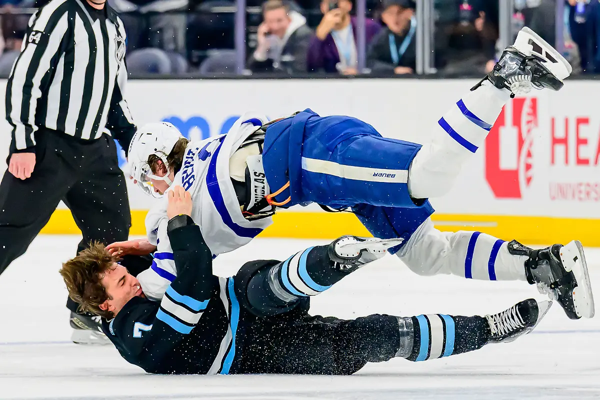 Utah-Hockey-Club-defenseman-Michael-Kesselring-7-throws-Toronto-Maple-Leafs-defenseman-Simon-Benoit-top-to-the-ice-in-a-fight-during-the-second-period-of-an-NHL-hockey-game-Monday-March-10-2025-in-Salt-Lake-City