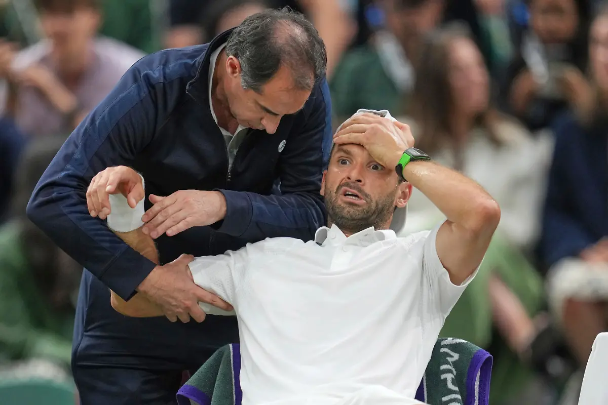 Bulgaria-s-Grigor-Dimitrov-gets-treatment-after-he-went-down-with-an-injury-which-forced-him-to-retire-injured-from-a-fourth-round-men-s-singles-match-against-Italy-s-Jannik-Sinner-at-the-Wimbledon-Tennis-Championships-in-London-Monday-July-7-2025