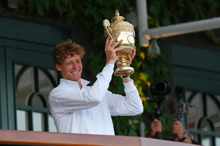 Italy-s-Jannik-Sinner-shows-the-trophy-from-the-balcony-of-Centre-Court-after-beating-Carlos-Alcaraz-of-Spain-to-win-the-men-s-singles-final-at-the-Wimbledon-Tennis-Championships-in-London-Sunday-July-13-2025