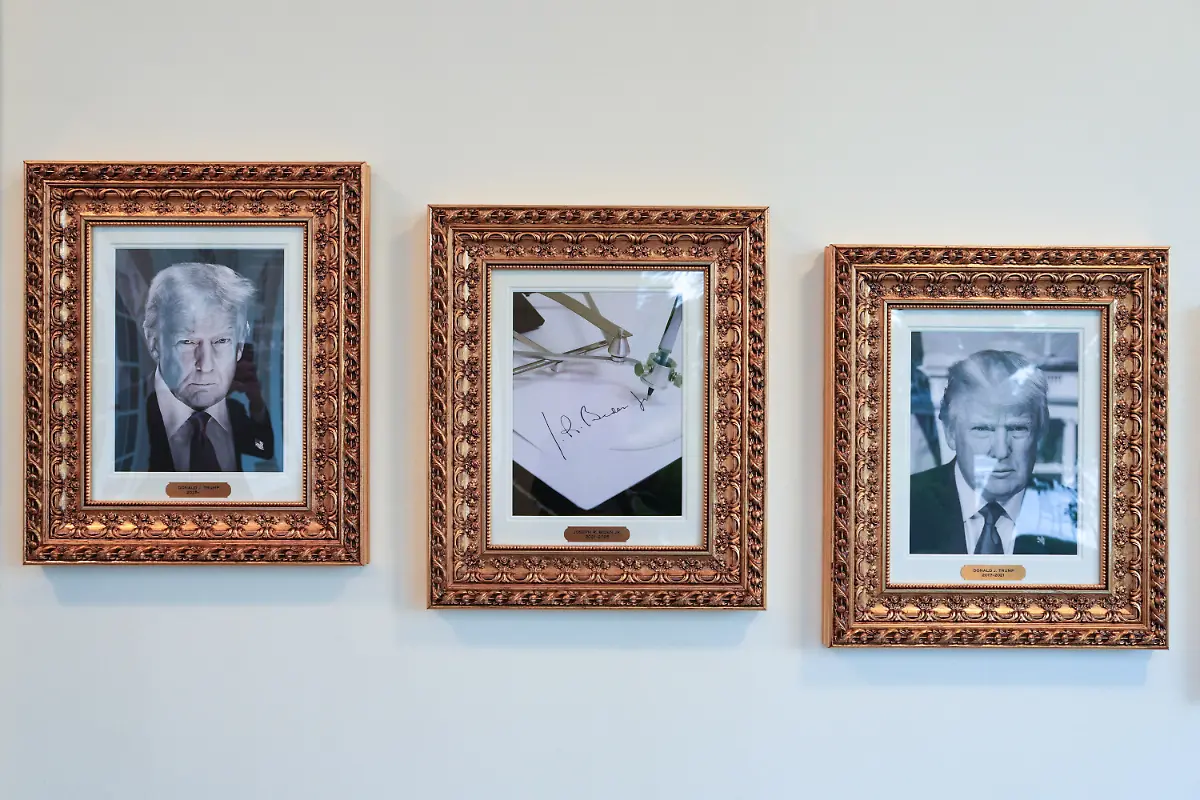 An-image-of-an-autopen-signing-former-U-S-President-Joe-Biden-s-signature-is-displayed-in-place-of-a-portrait-Biden-next-to-portraits-of-U-S-President-Donald-Trump-at-the-Presidential-Walk-of-Fame-along-the-Colonnade-at-the-White-House-in-Washington-D-C-U-S-September-30-2025