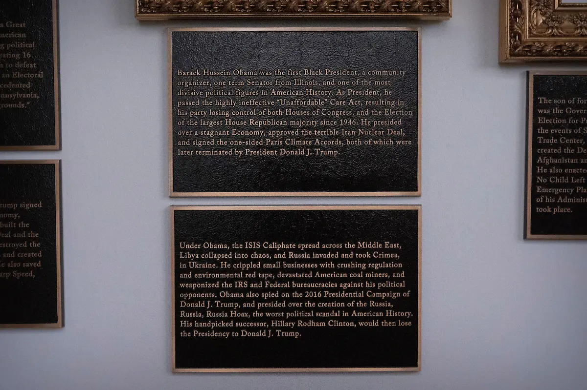 Plaques-of-explanatory-text-are-seen-beneath-a-framed-portrait-of-former-President-Barack-Obama-on-the-Presidential-Walk-of-Fame-on-the-Colonnade-of-the-White-House-Wednesday-Dec-17-2025-in-Washington