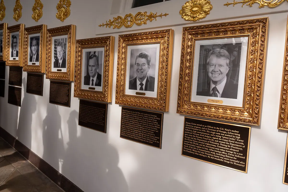 New-plaques-of-explanatory-text-have-been-placed-underneath-presidential-portraits-on-the-Colonnade-at-the-White-House-Wednesday-Dec-17-2025-in-Washington