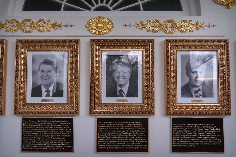 Portraits-of-former-Presidents-Ronald-Reagan-Jimmy-Carter-and-Gerald-Ford-with-plaques-of-text-below-are-seen-on-the-Presidential-Walk-of-Fame-on-the-Colonnade-of-the-White-House-Wednesday-Dec-17-2025-in-Washington