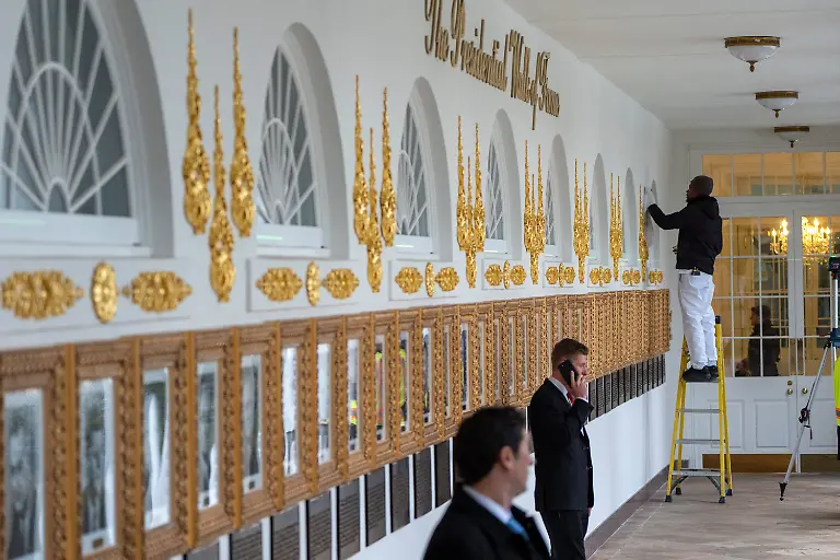 Work-continues-as-new-plaques-of-explanatory-text-have-been-placed-underneath-presidential-portraits-on-the-Colonnade-at-the-White-House-Wednesday-Dec-17-2025-in-Washington