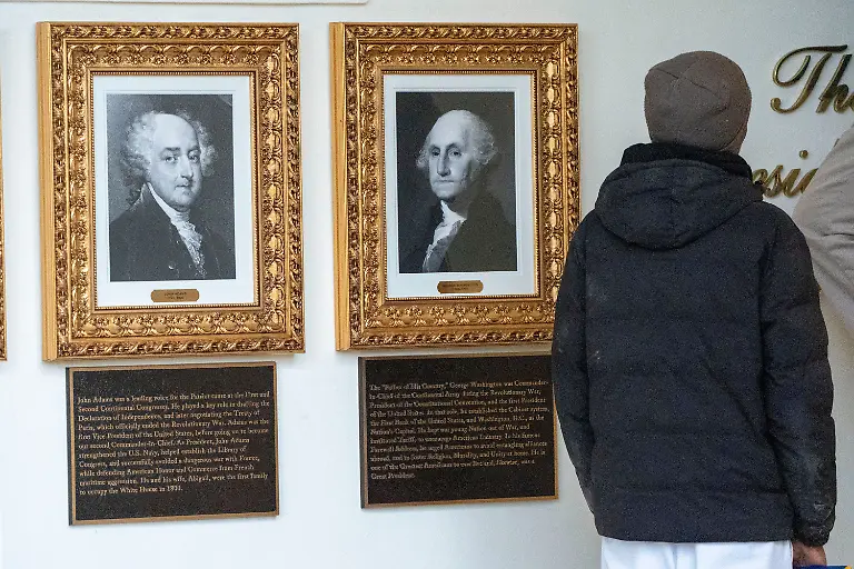 New-plaques-of-explanatory-text-have-been-placed-underneath-presidential-portraits-on-the-Colonnade-at-the-White-House-Wednesday-Dec-17-2025-in-Washington