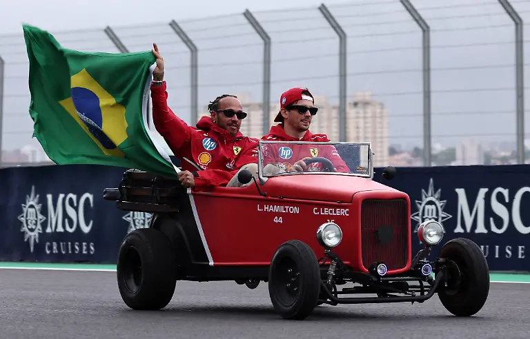 Formula-One-F1-Sao-Paulo-Grand-Prix-Autodromo-Jose-Carlos-Pace-Sao-Paulo-Brazil-November-9-2025-Ferrari-s-Lewis-Hamilton-holds-a-Brazil-flag-with-Ferrari-s-Charles-Leclerc-during-the-drivers-parade-before-the-race-REUTERS-Amanda-Perobelli-TPX-IMAGES-OF-THE-DAY