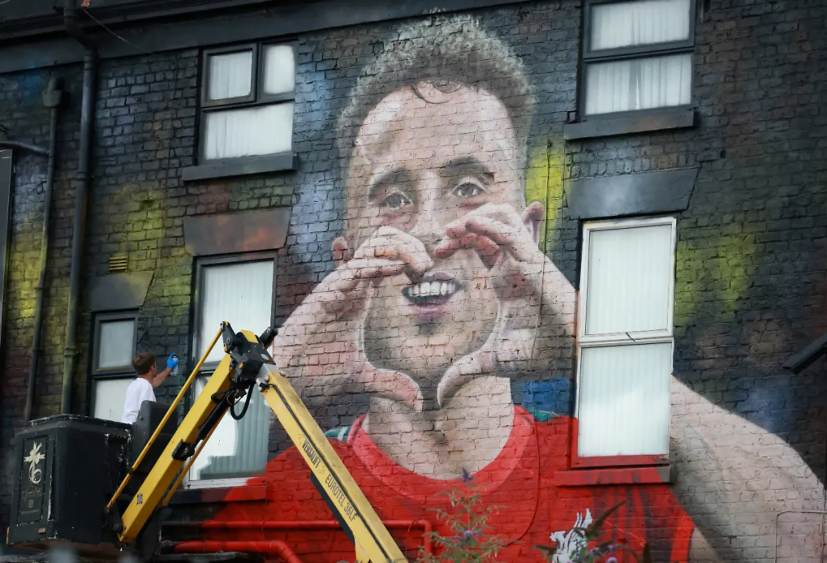 Artist-John-Culshaw-works-on-a-mural-of-late-Liverpool-player-Diogo-Jota-on-the-side-of-a-pub-in-Liverpool-Britain-July-14-2025