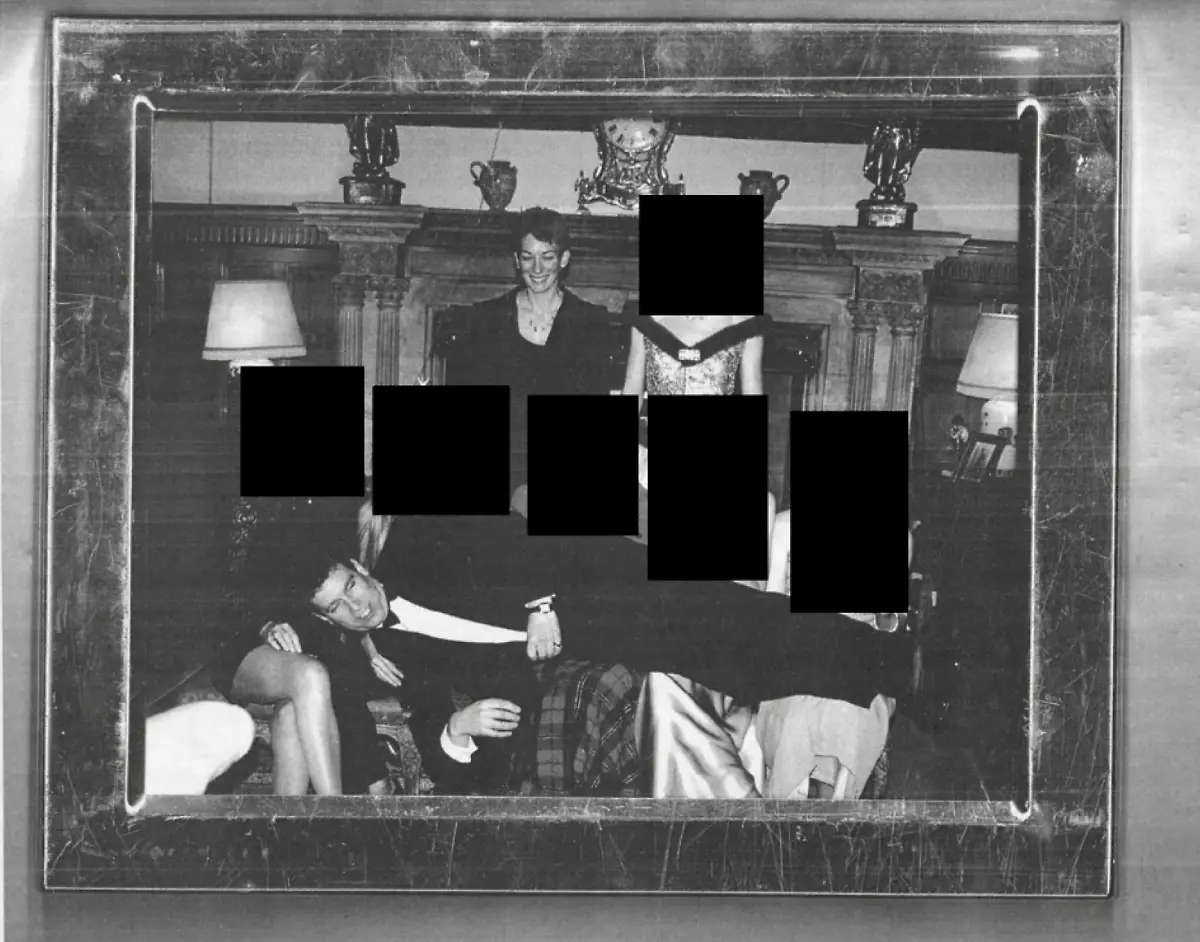 December-19-2025-Unknown-Unknown-Unknown-DATE-and-LOCATION-UNIDENTIFIED-The-Department-Of-Justice-has-released-files-tied-to-convicted-sex-offender-Jeffrey-Epstein-Andrew-Mountbatten-Windsor-formerly-PRINCE-ANDREW-laying-across-the-laps-of-several-women-while-GHISLAINE-MAXWELL-stands-in-the-background-The-women-s-faces-are-redacted-in-the-photo