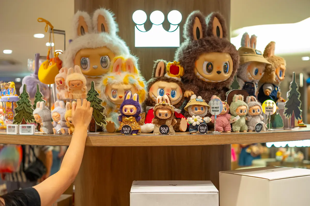 A-customer-picks-a-Labubu-from-a-display-shelf-at-a-Pop-Mart-shop-at-the-Siam-Center-The-store-opened-on-July-17th-2025