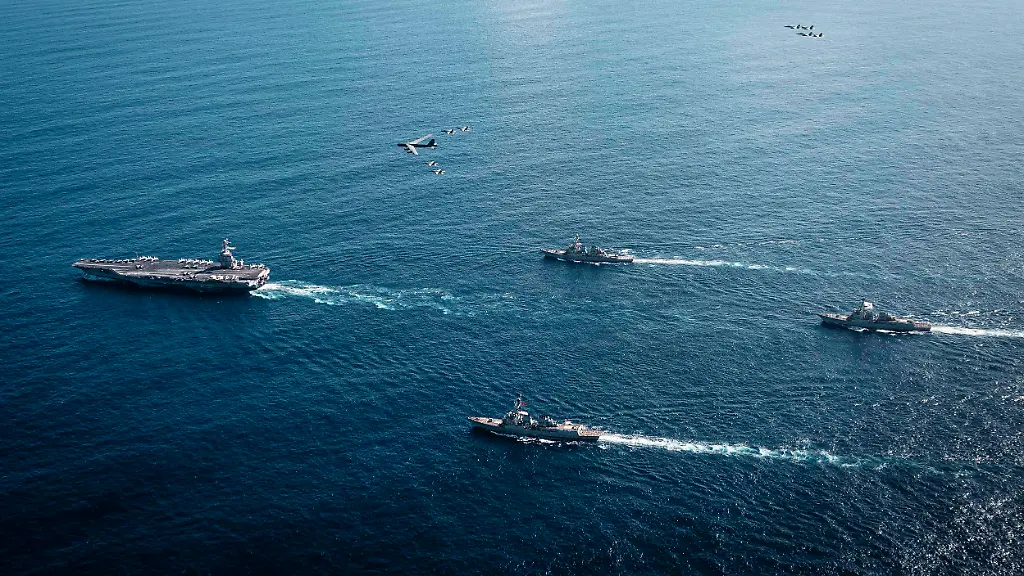 November-13-2025-Caribbean-Sea-International-Waters-Aerial-view-of-the-U-S-Navy-Ford-class-aircraft-carrier-USS-Gerald-R-Ford-leading-a-formation-of-guided-missile-destroyers-as-a-U-S-Air-Force-B-52-bomber-and-Navy-fighter-aircraft-fly-above-November-13-2025-on-the-Caribbean-Sea-U-S-President-Trump-ordered-the-Ford-Carrier-Group-to-the-Caribbean-in-a-show-of-force-against-Venezuela-Credit-Image-A-Mc2-Tajh-Payne-U-S