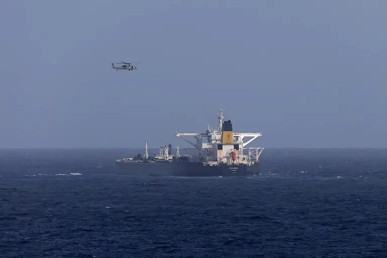 A-U-S-military-helicopter-flies-over-the-Panama-flagged-Centuries-which-was-intercepted-by-the-U-S-Coast-Guard-days-after-U-S-President-Donald-Trump-announced-a-blockade-of-all-sanctioned-oil-tankers-entering-and-leaving-Venezuela-east-of-Barbados-in-the-Caribbean-Sea-December-20-2025
