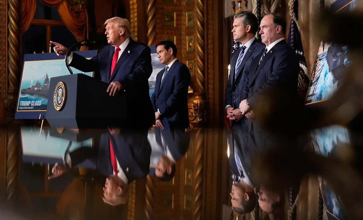 President-Donald-Trump-speaks-with-from-left-Secretary-of-State-Marco-Rubio-Defense-Secretary-Pete-Hegseth-and-Secretary-of-the-Navy-John-Phelan-at-his-Mar-a-Lago-club-Monday-Dec-22-2025-in-Palm-Beach-Fla