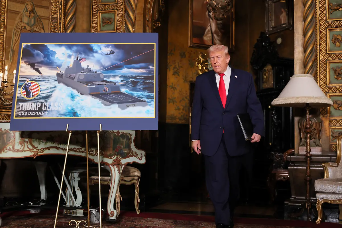 U-S-President-Donald-Trump-walks-past-a-rendering-of-the-Trump-Class-USS-Deifant-at-Mar-a-lago-in-Palm-Beach-Florida-U-S-December-22-2025
