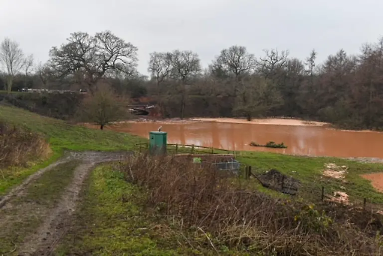 Whitchurch-sinkhole-The-scene-in-Whitchurch-Shropshire-where-emergency-services-have-declared-a-major-incident-after-receiving-reports-at-4-22am-this-morning-of-a-sinkhole-causing-large-volumes-of-water-to-escape-onto-land-in-the-Chemistry-area-of-Whitchurch-Ten-people-have-been-helped-to-safety-after-a-50-metre-long-sinkhole-breached-a-canal-in-Shropshire-leaving-several-narrow-boats-stranded-Picture-date-Monday-December-22-2025