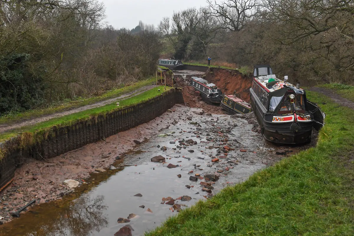 Whitchurch-sinkhole-The-scene-in-Whitchurch-Shropshire-where-emergency-services-have-declared-a-major-incident-after-receiving-reports-at-4-22am-this-morning-of-a-sinkhole-causing-large-volumes-of-water-to-escape-onto-land-in-the-Chemistry-area-of-Whitchurch-Ten-people-have-been-helped-to-safety-after-a-50-metre-long-sinkhole-breached-a-canal-in-Shropshire-leaving-several-narrow-boats-stranded-Picture-date-Monday-December-22-2025