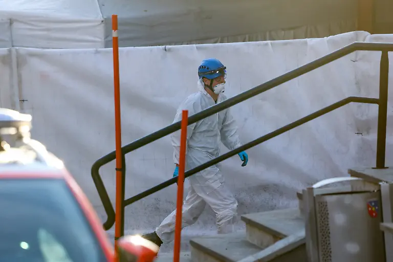 A-forensics-specialist-works-at-the-Le-Constellation-bar-after-a-fire-and-explosion-during-a-New-Year-s-Eve-party-where-several-people-died-and-others-were-injured-according-to-Swiss-police-in-the-upscale-ski-resort-of-Crans-Montana-in-southwestern-Switzerland-January-1-2026