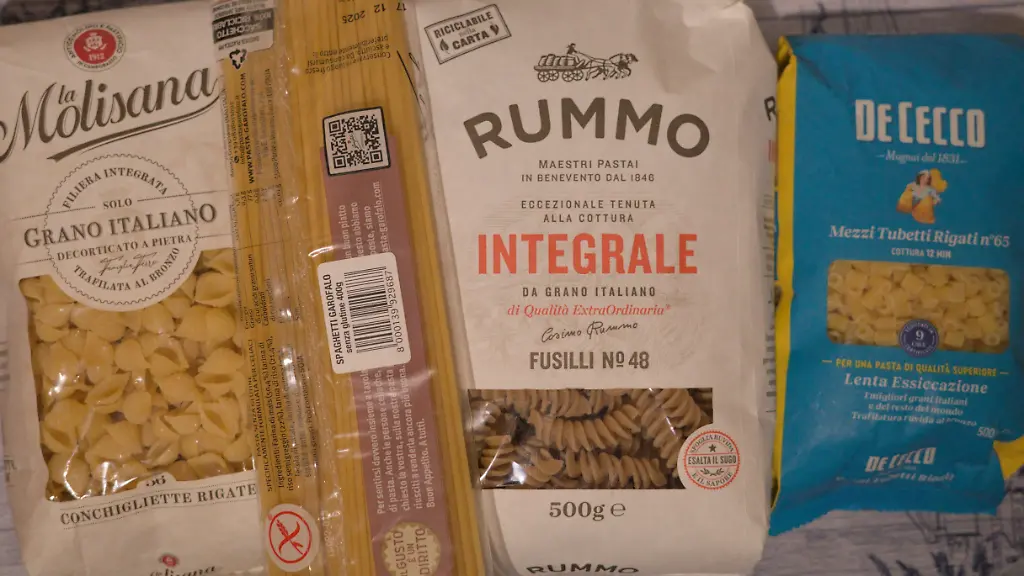 Packages-of-Italian-pasta-from-different-brands-including-La-Molisana-Rummo-and-De-Cecco-are-displayed-on-a-table-in-Palermo-Italy-on-December-10-2025-UNESCO-has-added-Italian-cuisine-to-its-list-of-intangible-cultural-heritage