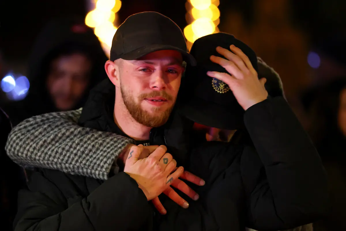 People-react-outside-the-Le-Constellation-bar-after-a-fire-and-explosion-during-a-New-Year-s-Eve-party-where-several-people-died-and-others-were-injured-according-to-Swiss-police-in-the-upscale-ski-resort-of-Crans-Montana-in-southwestern-Switzerland-January-1-2026