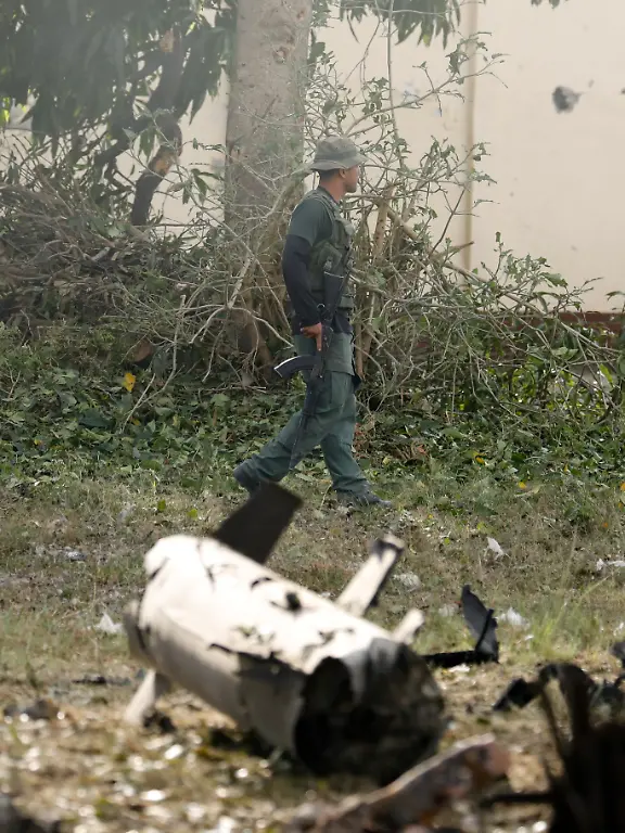 A-military-personnel-member-walks-past-debris-at-La-Carlota-military-air-base-after-U-S-President-Donald-Trump-said-the-U-S-has-struck-Venezuela-and-captured-its-President-Nicolas-Maduro-in-Caracas-Venezuela-January-3-2026