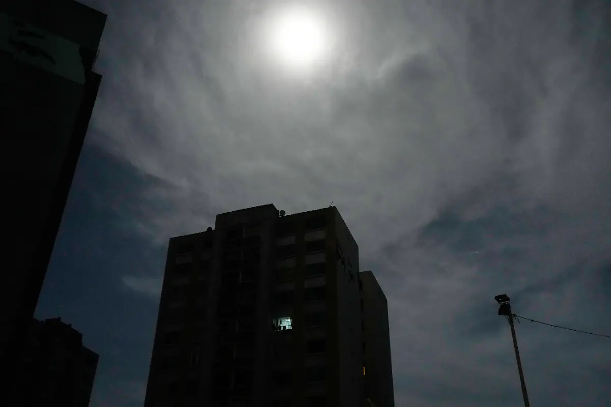 The-moon-shines-over-a-residential-area-near-Fort-Tiuna-the-main-military-garrison-in-Caracas-Venezuela-which-has-no-electricity-after-explosions-and-low-flying-aircraft-were-heard-Saturday-Jan-3-2026