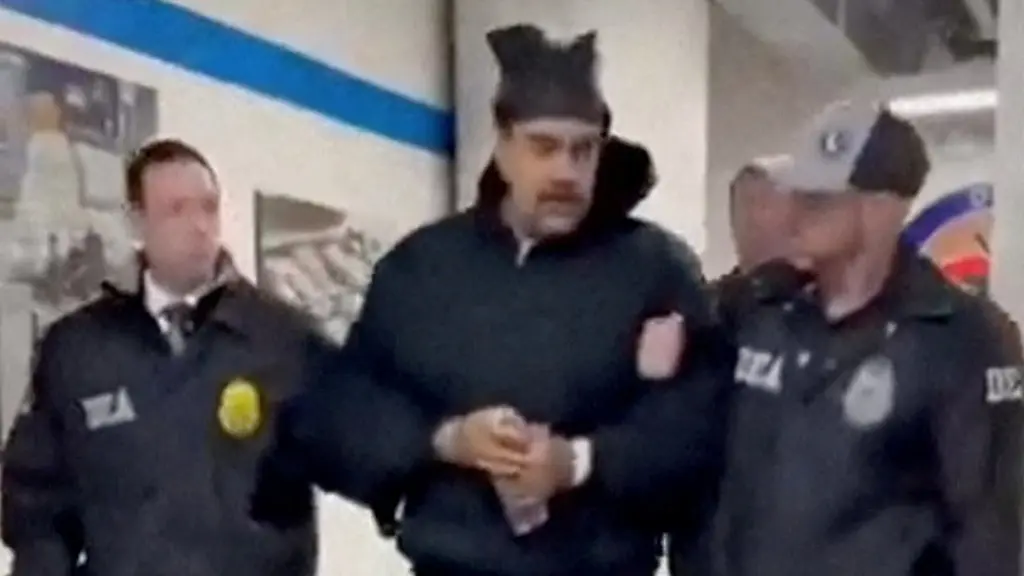 A-still-image-from-video-posted-by-the-White-House-s-Rapid-Response-47-account-on-X-com-which-originated-from-the-PaulDMauro-account-shows-Venezuela-s-President-Nicolas-Maduro-being-walked-in-custody-down-a-hallway-at-the-offices-of-the-U-S-Drug-Enforcement-Administration-DEA-in-New-York-City-U-S-January-3-2026-RapidResponse47-Handout-via-REUTERS-THIS-IMAGE-HAS-BEEN-SUPPLIED-BY-A-THIRD-PARTY-MANDATORY-CREDIT-NO-RESALES-NO-ARCHIVES-Verification-Reuters-was-able-to-confirm-footage-of-Nicolas-Maduro-walking-through-the-halls-of-DEA-headquarters-in-New-York-as-seen-on-corroborating-footage-showing-same-personnels-ushering-Maduro-and-DEA-NYD-crest-on-the-wall-Logo-on-wall-matched-DEA-NYD-from-file-images-Reuters-witness-footage-showing-convoy-arriving-at-DEA-headquarters-in-Manhattan