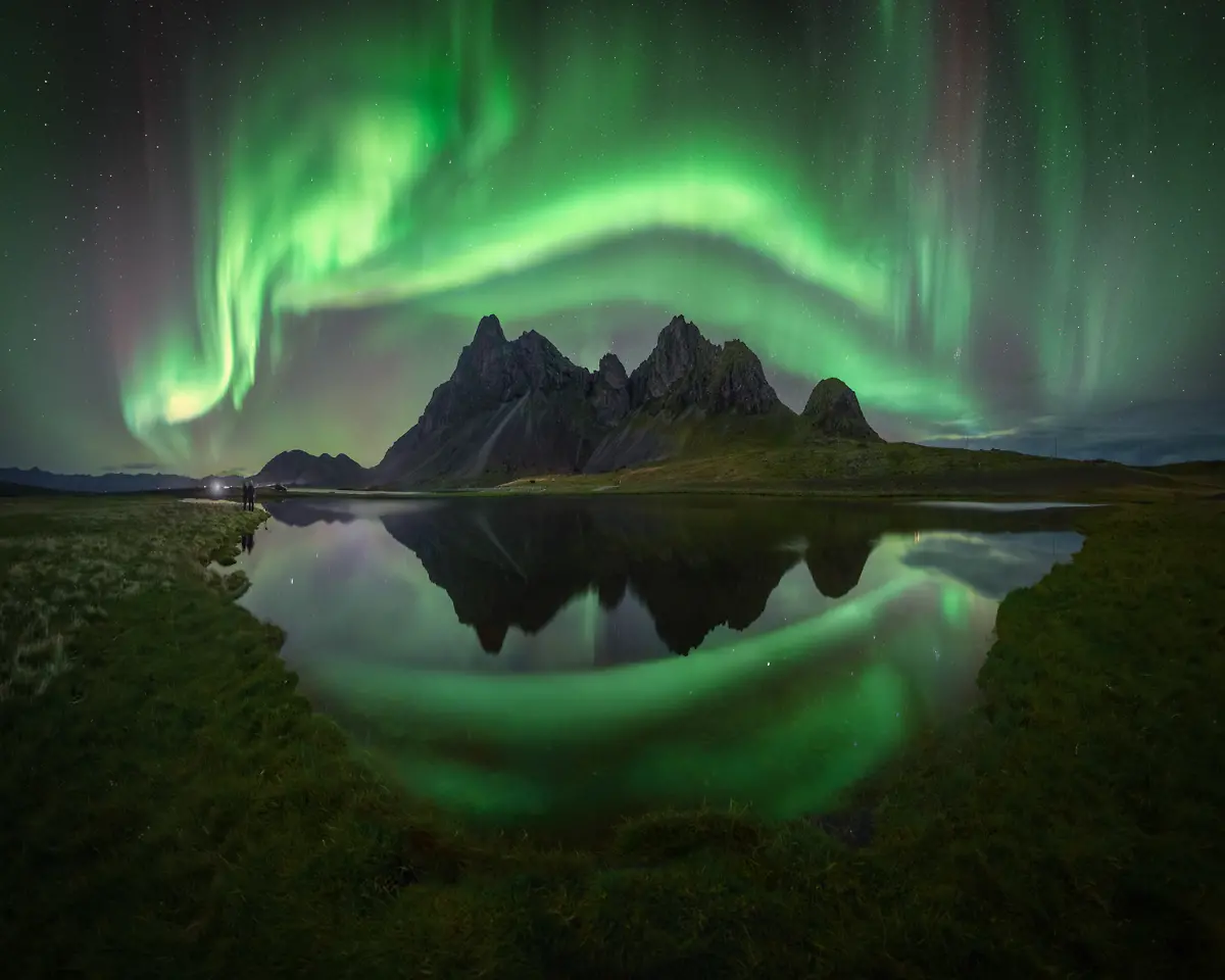 Without-a-doubt-one-of-the-most-challenging-aurora-panoramas-I-ve-ever-taken-was-this-one-at-one-of-Iceland-s-most-spectacular-locations-Capturing-a-panorama-with-reflections-and-auroras-that-move-so-quickly-is-quite-difficult-It-was-the-photograph-of-my-dreams-so-I-arrived-in-the-afternoon-to-prepare-the-angles-and-options-for-the-night-Clear-skies-and-very-little-wind-looked-perfect-for-capturing-reflections-in-the-different-pools-Auroras-were-already-visible-in-the-sky-during-the-blue-hour-so-I-quickly-headed-to-the-spot-where-I-had-planned-the-composition-The-wind-shifted-making-it-difficult-to-capture-the-reflections-but-the-moment-the-sky-exploded-the-wind-stopped-and-for-a-few-brief-moments-I-achieved-my-dream-photograph-It-was-a-great-joy-to-witness-and-capture-such-a-moment
