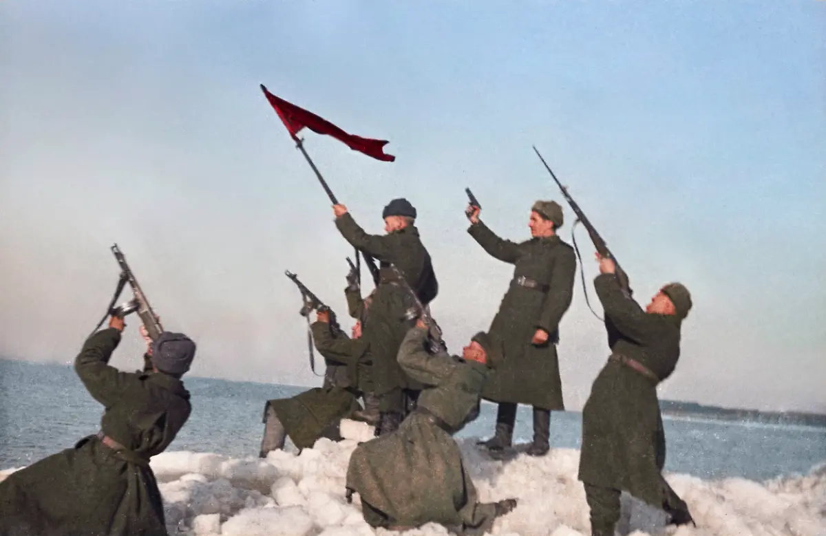 March-1945-East-Prussia-Germany-Red-Army-soldiers-of-the-3rd-Belorussian-Front-shoot-into-the-sky-on-the-shore-of-the-Baltic-Sea-during-the-Second-World-War-The-exact-date-of-the-photograph-is-unknown-AI-Colourised-from-original-ID-32392332