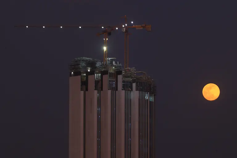 BAGHDAD-IRAQ-JANUARY-25-Full-moon-rises-over-the-Central-Bank-of-Iraq-Tower-in-Baghdad-Iraq-on-January-25-2024