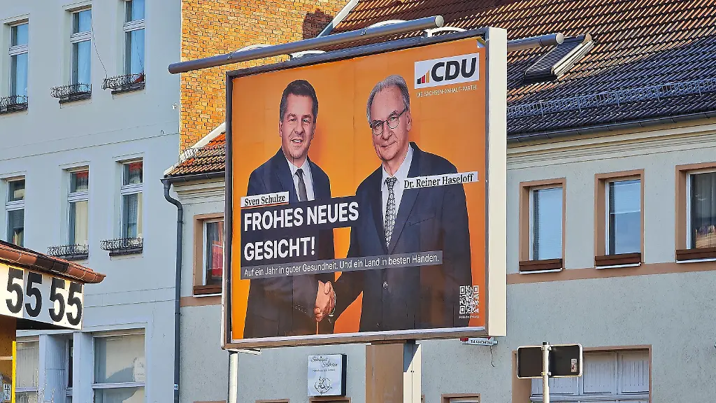Aschersleben-Sachsen-Anhalt-Deutschland-Plakat-mit-Wirtschaftsminister-Sven-Schulze-und-Ministerpraesident-Reiner-Haseloff-und-dem-Slogan-Frohes-neues-Gesicht-Auf-ein-Jahr-in-guter-Gesundheit-Und-ein-Land-in-besten-Haenden-Die-CDU-kaempft-im-Jahr-der-Landtagswahl-mit-dem-Problem-dass-Spitzenkandidat-Schulze-nicht-an-die-Bekanntheitswerte-seines-Vorgaengers-Haseloff-kommt-und-die-AfD-in-Umfragen-klar-vorne-liegt