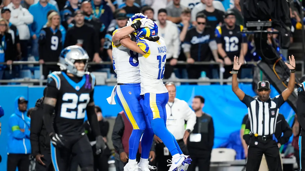 Los-Angeles-Rams-tight-end-Colby-Parkinson-center-left-celebrates-his-touchdown-catch-with-wide-receiver-Puka-Nacua-12-during-the-second-half-of-an-NFL-wild-card-playoff-football-game-against-the-Carolina-Panthers-Saturday-Jan-10-2026-in-Charlotte-N-C